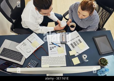 Business colleagues having video call discussing financial data working together in office. People entrepreneurs working with charts and tables on com Stock Photo