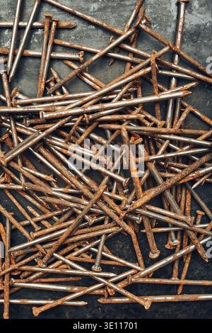 Rusty nails on steel surface. Tools for maintenance. Hardware tools to fix. Technical background with copy space Stock Photo