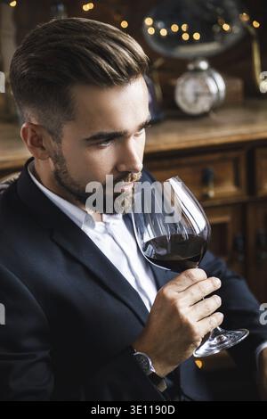 Portrait of handsome bearded man with a glass of red wine Stock Photo