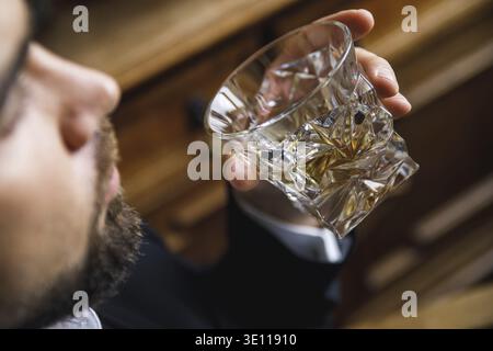 Bearded man with a glass of expensive whiskey Stock Photo