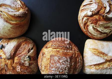 Bread. Assortment of different types of bread on a blackn background. Loaf, bun, baguette, cereal bread. Bakery products Stock Photo