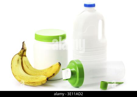 Protein shaker, big bottle of milk and bananas on white background Stock Photo