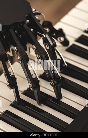 Concepts of prosthetics or artificial intelligence. Human with neural hand prosthesis playing piano Stock Photo