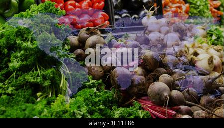 Displaying central heap of beetroots with stems at market stall, showing digital world map overlay Stock Photo
