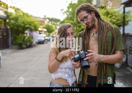 Portrait of young Hispanic tourist couple together in the streets outdoors Stock Photo