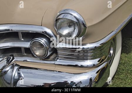 Vintage beige classic car showcasing chrome details, headlights, and grille Stock Photo