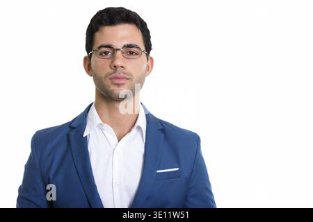 Studio shot of young handsome Hispanic businessman wearing eyeglasses Stock Photo