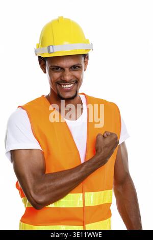 Young happy African man construction worker smiling with hand on chest Stock Photo