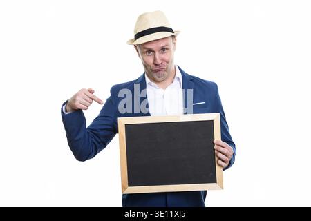 Studio shot of mature businessman holding blank blackboard and pointing finger Stock Photo
