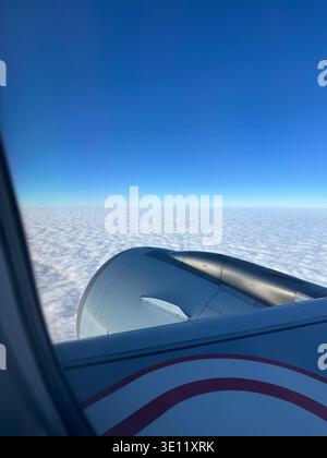 Dramatic and fluffy cloudscape with the airplane from the airplane's window Stock Photo