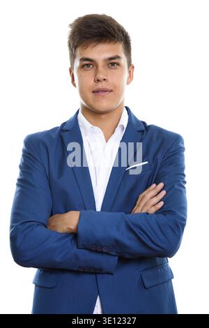 Studio shot of young handsome man wearing tuxedo with arms crossed Stock Photo