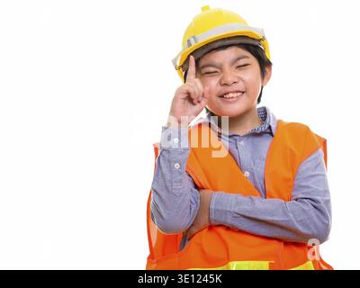 Happy Japanese boy construction worker smiling while pointing finger up Stock Photo