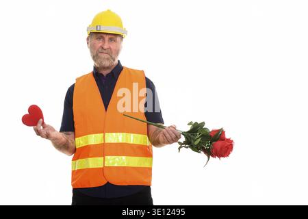 Sad mature bearded man construction worker holding red heart and roses Stock Photo