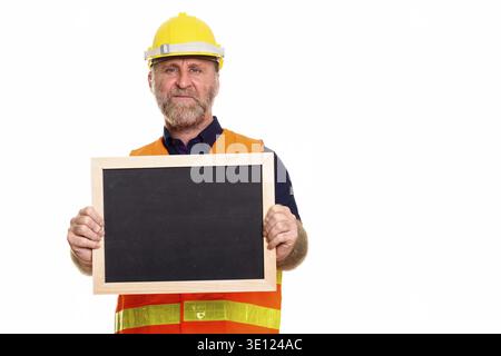 Mature bearded man construction worker holding blank blackboard Stock Photo
