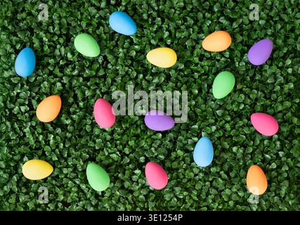 Easter colorful painted eggs on a green lawn. View from above. Easter time. Festive decor. Stock Photo
