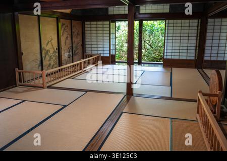 Tatami mats, shoji screens, and painted sliding doors adorn the serene interior of a historic house in Shirakawa-go, Japan Stock Photo