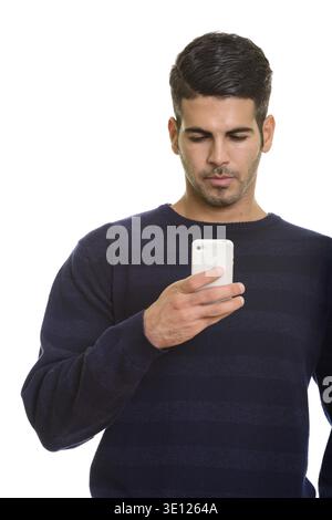 Young handsome Persian man using mobile phone isolated against white background Stock Photo