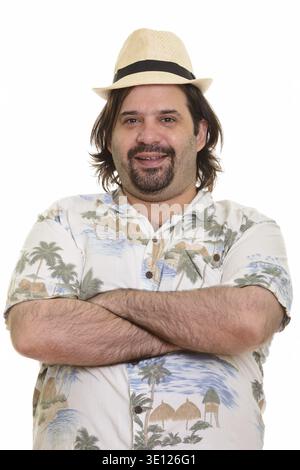Happy fat bearded Caucasian man smiling with arms crossed ready for vacation Stock Photo