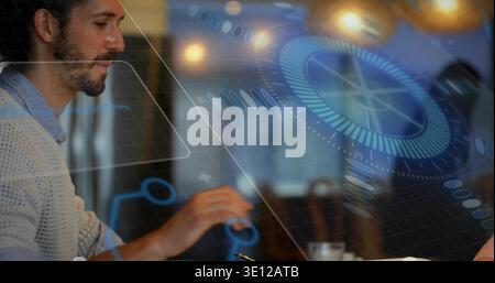 Working bearded man in cream sweater focusing on laptop at cafe with holographic UI, copy space Stock Photo