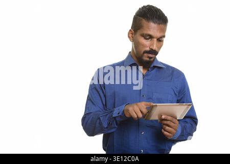 Young Indian businessman using digital tablet isolated against white background Stock Photo
