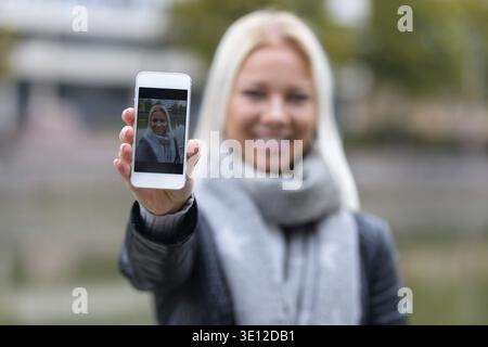 Portrait of young beautiful blonde Scandinavian woman relaxing by the river Stock Photo