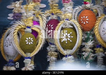 Closeup of handcrafted Easter eggs adorned with woven wheat and floral patterns, showcasing vibrant colors and intricate details Stock Photo