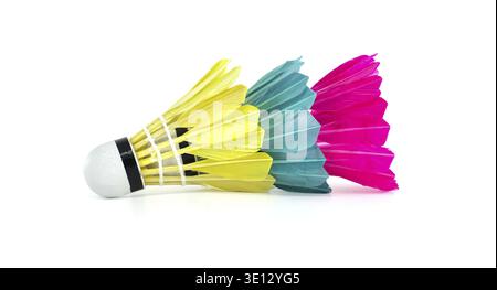 Close-up of three brightly colored badminton shuttlecocks arranged in a row on a white surface, perfect for sports or recreational concepts Stock Photo