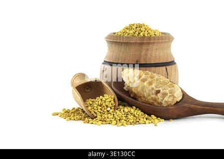 A close-up view of a natural arrangement featuring bee pollen granules, fresh honeycomb pieces, and wooden containers on a clean background, emphasizi Stock Photo