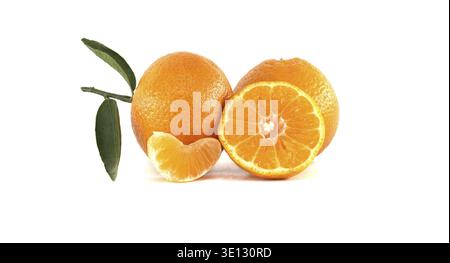 A vibrant arrangement of ripe tangerines, including a whole fruit, a sliced tangerine, and a fresh segment, accompanied by green leaves Stock Photo