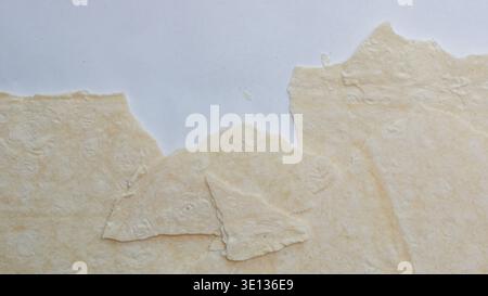Pieces of matzo on a white background, top view, sheets of rolled out dough on a white background. Stock Photo
