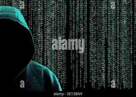 Cyber criminal in hood against programming code Stock Photo