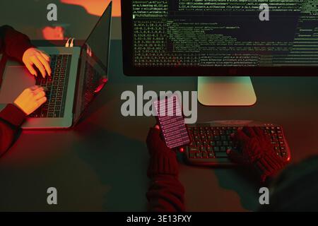 Anonymous people using computer and programming to break code. Cyber security threat. Internet and network security. Access to private information. An Stock Photo