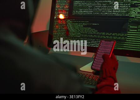 Anonymous people using computer and programming to break code. Cyber security threat. Internet and network security. Access to private information. An Stock Photo