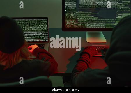 Anonymous people using computer and programming to break code. Cyber security threat. Internet and network security. Access to private information. An Stock Photo