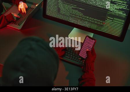 Anonymous people using computer and programming to break code. Cyber security threat. Internet and network security. Access to private information. An Stock Photo