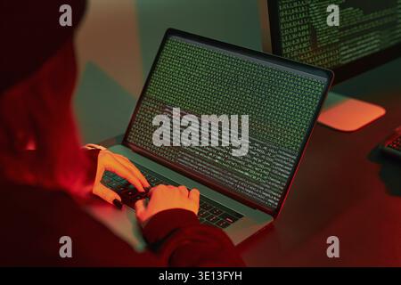 Anonymous people using computer and programming to break code. Cyber security threat. Internet and network security. Access to private information. An Stock Photo