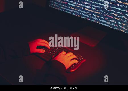 Man using computer and programming to break code. Cyber security threat. Internet and network security. Stealing private information. Person using tec Stock Photo