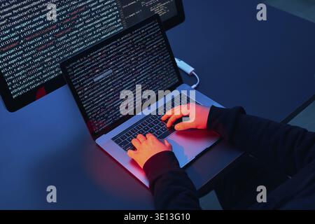 Man using computer and programming to break code. Cyber security threat. Internet and network security. Stealing private information. Person using tec Stock Photo