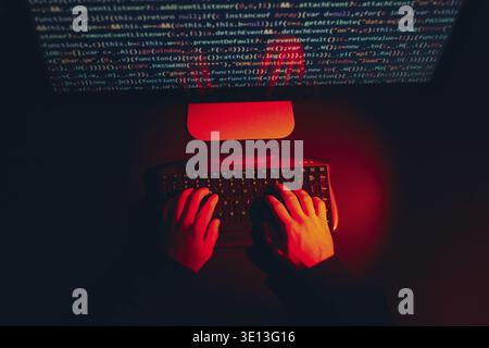 Man using computer and programming to break code. Cyber security threat. Internet and network security. Stealing private information. Person using tec Stock Photo
