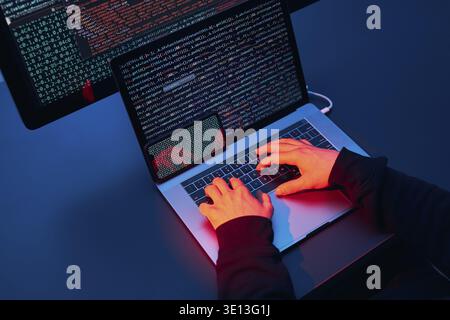 Man using computer and programming to break code. Cyber security threat. Internet and network security. Stealing private information. Person using tec Stock Photo