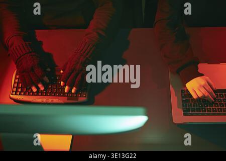 Anonymous people using computer and programming to break code. Cyber security threat. Internet and network security. Access to private information. An Stock Photo