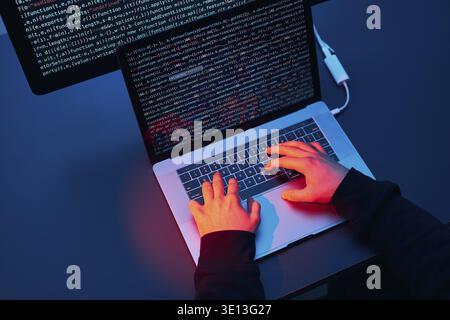 Man using computer and programming to break code. Cyber security threat. Internet and network security. Stealing private information. Person using tec Stock Photo