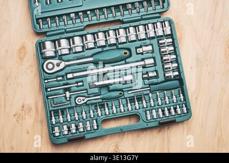 Ratchet with many attachments in plastic case. Work tools. Universal tool set. Background Stock Photo
