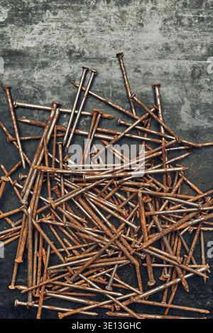 Rusty nails on steel surface. Tools for maintenance. Hardware tools to fix. Technical background with copy space Stock Photo