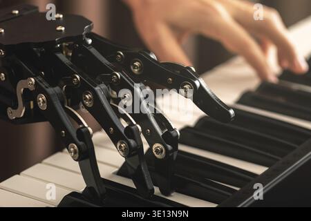 Concepts of prosthetics or artificial intelligence. Human with neural hand prosthesis playing piano Stock Photo
