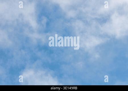Blue sky with soft white clouds and gentle natural cloud formations Stock Photo