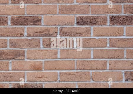 Textured beige brick wall with natural variation and rough surface detail Stock Photo
