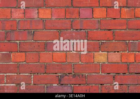 Weathered red brick wall texture with natural variation and aged surface detail Stock Photo