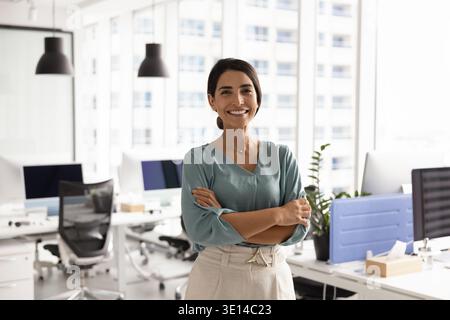 Confident Latina female business leader posing for portrait in office Stock Photo