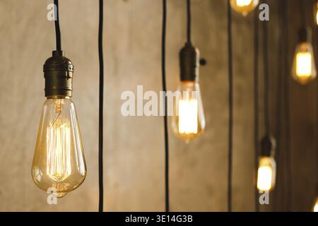 A lot of vintage filament light bulbs hanging from the ceiling Stock Photo